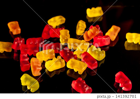 Marmalade bears scattered on a flat surface in bright colors 141392701