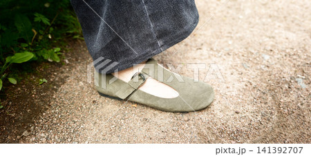Shoe on a gravel path near plants during the day 141392707