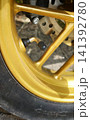 Close-up view of a scooter wheel nipple in a sunny outdoor setting 141392780