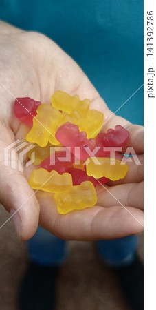 Marmalade bears held in a hand, bright colors and sweet shapes 141392786