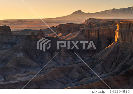 Beautiful peaceful sunrise illuminates majestic desert landscape of deep canyon valley and rugged mountain ridge located in utah usa showcasing awe inspiring raw nature Beautiful peaceful sunrise illuminates majestic desert landscape of deep canyon valley and rugged mountain ridge located in utah usa showcasing awe inspiring raw nature 141394956
