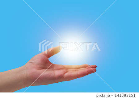 Human hand holding glowing light flare Human hand holding glowing light flare 141395151