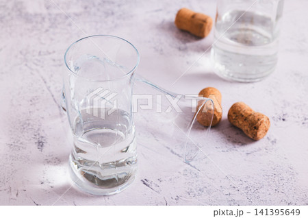 Staying sober in dry January, glasses and a bottle on the table 141395649