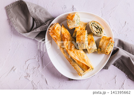 Close up of delicious grilled rolls with cottage cheese, cheese and herbs on a plate on the table top view 141395662