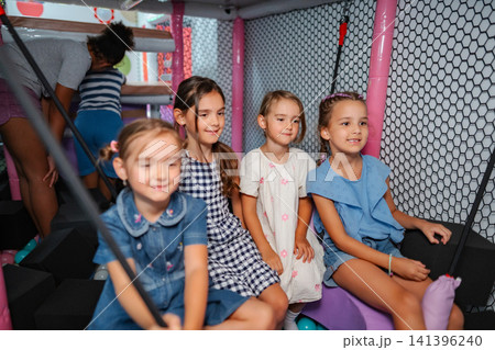 Group of young girls having fun at indoor playground 141396240