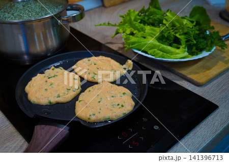 Frying homemade vegetable pancakes on nonstick pan with copy space Frying homemade vegetable pancakes on nonstick pan with copy space 141396713