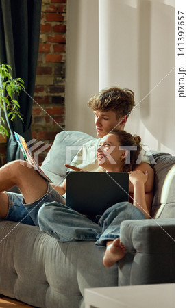 Young couple planning apartment color scheme with laptops and swatches Young couple planning apartment color scheme with laptops and swatches 141397657