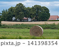 cottag and straw bales in the field 141398354