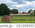 cottag and straw bales in the field 141398355