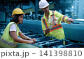 Ai using. Engineers and technicians use AI technology to inspect industrial machinery. Workers using Ai and augmented reality to optimize manufacturing process. Smart factory innovation. Industry tech 141398810