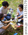 Young adults volunteer planting trees in the park for environmental conservation and sustainable future. Community service, reforestation, nature care and teamwork concept. 141399179
