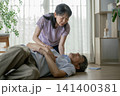 夫が倒れて意識確認をする妻 141400381