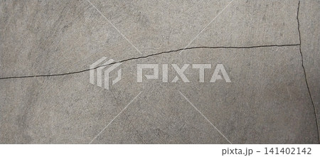 Horizontal and vertical cracks on a smooth gray concrete surface. Horizontal and vertical cracks on a smooth gray concrete surface. 141402142