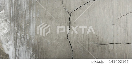 Vertical structural cracks in weathered gray concrete surface. Vertical structural cracks in weathered gray concrete surface. 141402165