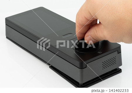 Finger touches a smart device at home during the day 141402233