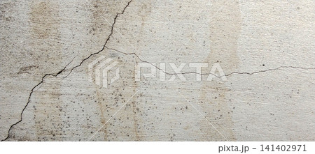 Texture of a weathered concrete wall with cracks and water stains. Texture of a weathered concrete wall with cracks and water stains. 141402971
