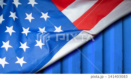A high-quality close-up photograph of the United States flag folded over a vibrant blue corrugated metal background, symbolizing patriotism, industry, and national pride 141403083
