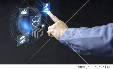 A close-up of a professional person interacting with a futuristic, holographic digital user interface displaying icons for skill development and technology in a modern corporate concept 141403148