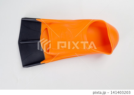 A single orange and black rubber swim fin or flipper, used for swimming, snorkeling, or diving training, shot from above on a clean white background 141403203