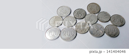 Various Indonesian Rupiah coins against a white background with empty space. Various Indonesian Rupiah coins against a white background with empty space. 141404046
