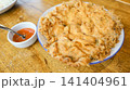 crispy fried chicken on rice cake with sauce 141404961