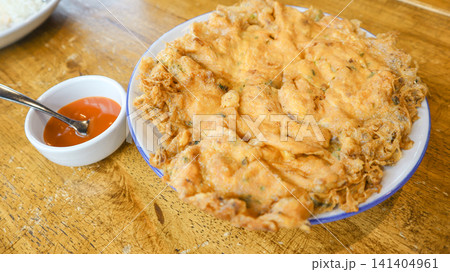 crispy fried chicken on rice cake with sauce crispy fried chicken on rice cake with sauce 141404961