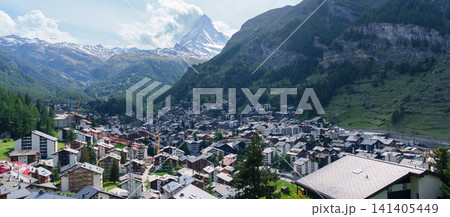 Scenic View of Zermatt Village with Iconic Matterhorn Mountain, Switzerland, Traditional Alpine Town and Snow Capped Swiss Alps under Blue Sky, Famous Landmark and popular Europe Travel Destination Scenic View of Zermatt Village with Iconic Matterhorn Mountain, Switzerland, Traditional Alpine Town and Snow Capped Swiss Alps under Blue Sky, Famous Landmark and popular Europe Travel Destination 141405449