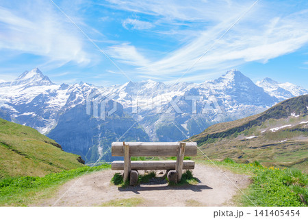 Scenic view of Swiss Alps with bench for taking view at Grindelwald First, Switzerland. Beautiful landscape in Jungfrau Region. famous Europe summer hiking trail and travel destination Scenic view of Swiss Alps with bench for taking view at Grindelwald First, Switzerland. Beautiful landscape in Jungfrau Region. famous Europe summer hiking trail and travel destination 141405454