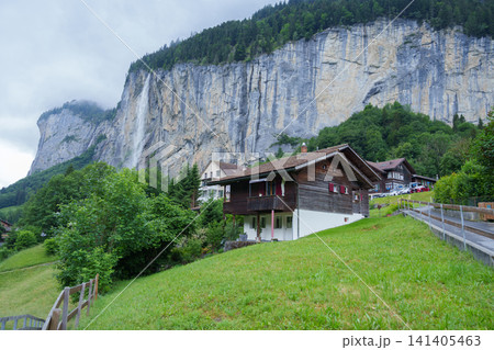 Scenic View of Lauterbrunnen Village with Staubbach Falls and Swiss Alps, Bernese Oberland in the canton of Bern, Switzerland. Picturesque Alpine Landscape and Famous Europe Travel Destination Scenic View of Lauterbrunnen Village with Staubbach Falls and Swiss Alps, Bernese Oberland in the canton of Bern, Switzerland. Picturesque Alpine Landscape and Famous Europe Travel Destination 141405463