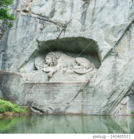 Famous historic Lion Monument sculpture landmark in Lucerne, Switzerland. Scenic view of Lowendenkmal rock relief carving on cliff wall, popular Europe travel destination and iconic tourist site Famous historic Lion Monument sculpture landmark in Lucerne, Switzerland. Scenic view of Lowendenkmal rock relief carving on cliff wall, popular Europe travel destination and iconic tourist site 141405511