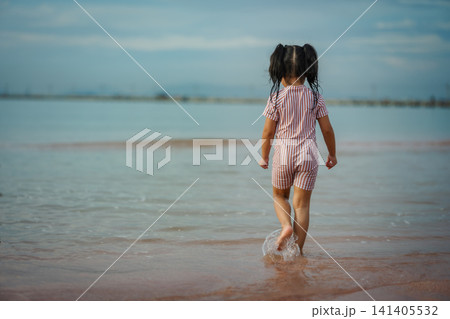 preschool child girl walking on sea beach in Pattaya, Thailand 141405532