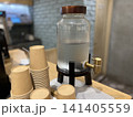 台の上の冷水ディスペンサーと紙コップ 141405559