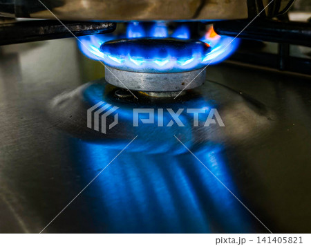 Blue Gas Flame Burning on Kitchen Stove Close Up Blue Gas Flame Burning on Kitchen Stove Close Up 141405821