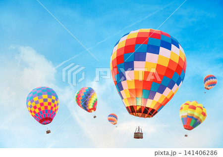 International Hot Air Balloon Festival Concept: Colorful Airships Soaring in Open Blue Sky International Hot Air Balloon Festival Concept: Colorful Airships Soaring in Open Blue Sky 141406286
