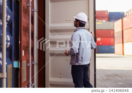 Logistics worker checking shipping container with digital tablet Logistics worker checking shipping container with digital tablet 141406848