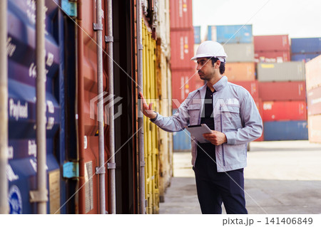 Logistics worker checking shipping container with digital tablet Logistics worker checking shipping container with digital tablet 141406849