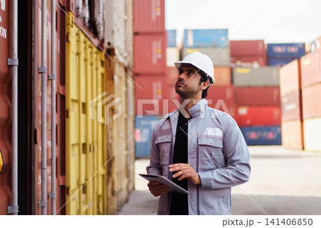 Logistics worker checking shipping container with digital tablet Logistics worker checking shipping container with digital tablet 141406850