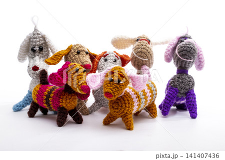 Several knitted woolen dogs on a white background 141407436