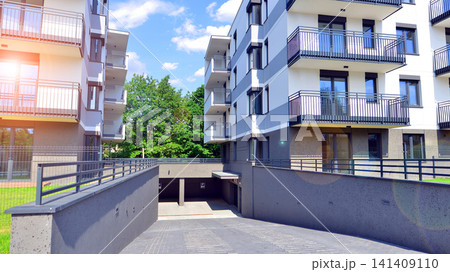 European residential architecture harmonizing with nature. Eco-friendly living in city with greens. Eco apartment building saving energy and fresh air concept. European residential architecture harmonizing with nature. Eco-friendly living in city with greens. Eco apartment building saving energy and fresh air concept. 141409110