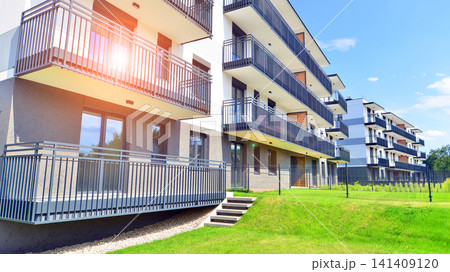 European residential architecture harmonizing with nature. Eco-friendly living in city with greens. Eco apartment building saving energy and fresh air concept.  141409120