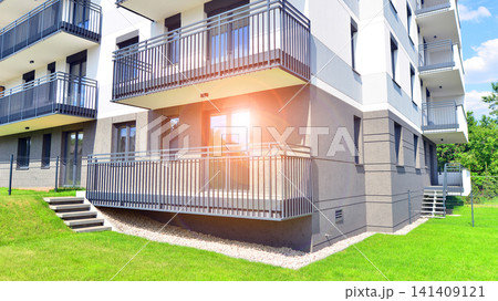 European residential architecture harmonizing with nature. Eco-friendly living in city with greens. Eco apartment building saving energy and fresh air concept. European residential architecture harmonizing with nature. Eco-friendly living in city with greens. Eco apartment building saving energy and fresh air concept. 141409121