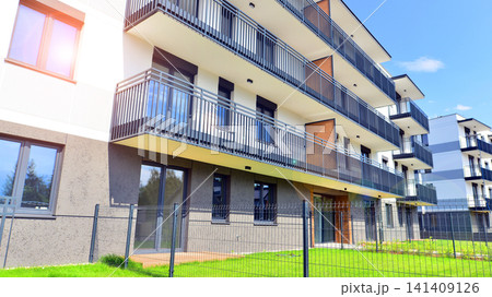 European residential architecture harmonizing with nature. Eco-friendly living in city with greens. Eco apartment building saving energy and fresh air concept.  141409126