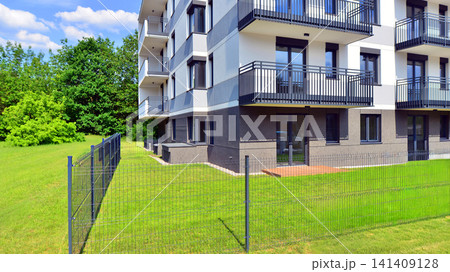 European residential architecture harmonizing with nature. Eco-friendly living in city with greens. Eco apartment building saving energy and fresh air concept. European residential architecture harmonizing with nature. Eco-friendly living in city with greens. Eco apartment building saving energy and fresh air concept. 141409128