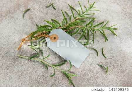 Fresh rosemary sprigs with blank tag on stone background 141409576
