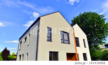 Newly constructed semi detached house for families. Modern design, technology, and real estate market concept. Newly constructed semi detached house for families. Modern design, technology, and real estate market concept. 141410088