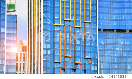 View of modern residential building with glass balconies and bright facade. Contemporary apartment building in european city. Concept of urban living and modern architecture. View of modern residential building with glass balconies and bright facade. Contemporary apartment building in european city. Concept of urban living and modern architecture. 141410554