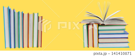 Books of various colors arranged neatly on a yellow backdrop 141410871