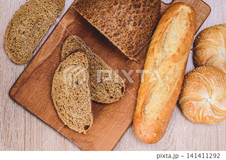 French baguettes. Fresh crispbread. Bread background. Different breed  on wooden background. 141411292