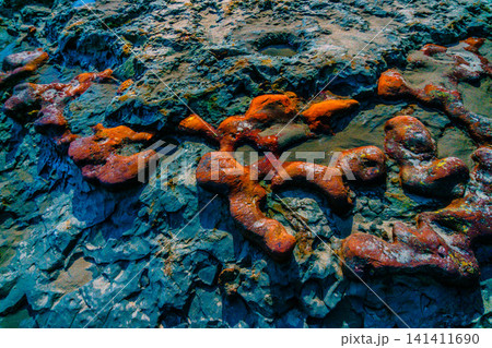 Aerial view of coastal rock formations rising from the sea with crashing waves and sandy beach in Indonesia Aerial view of coastal rock formations rising from the sea with crashing waves and sandy beach in Indonesia 141411690