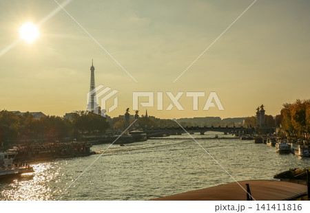 Eiffel Tower and Seine river at sunset with Pont Alexandre III, iconic Paris travel destination 141411816